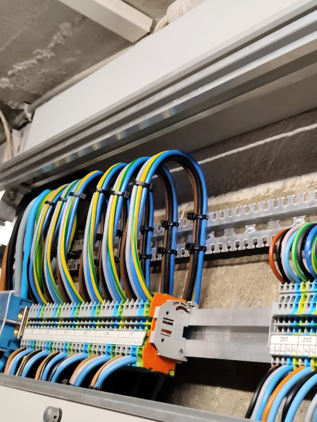 Labelled cables connected inside an open electrical distribution board