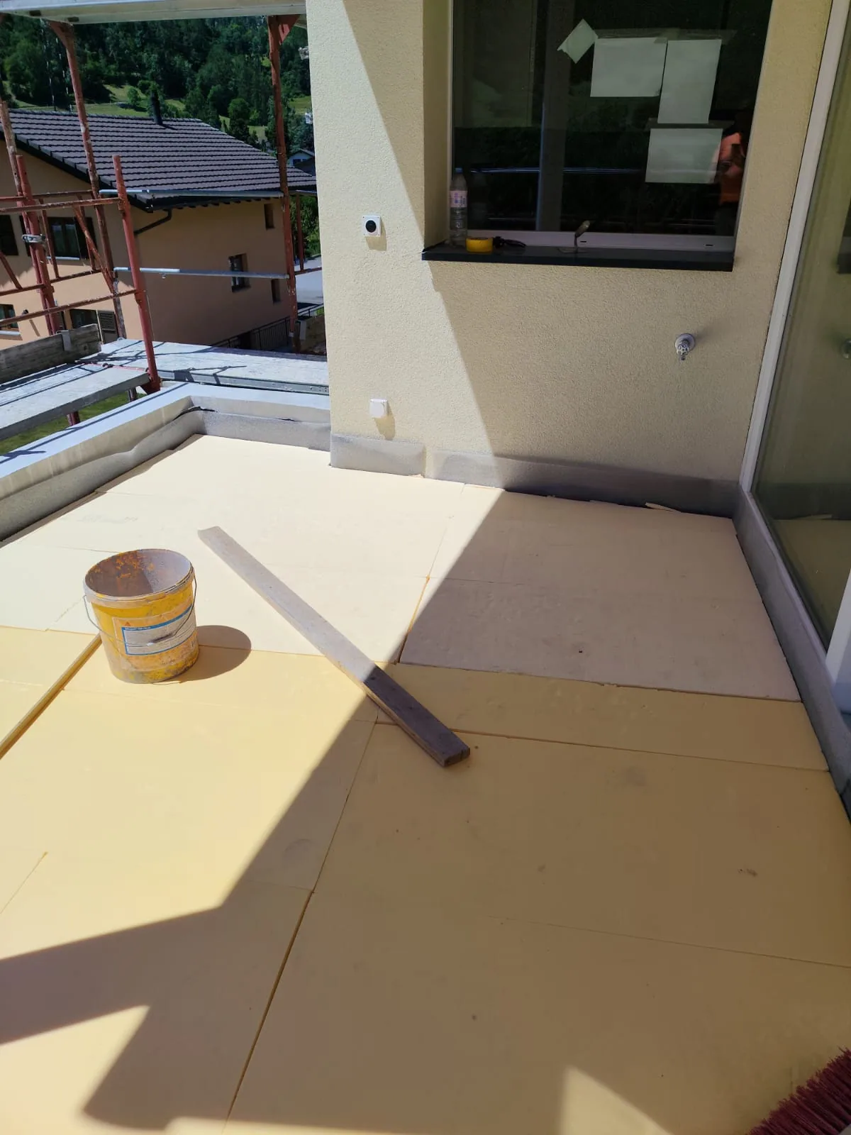 Insulation boards laid across a terrace under construction