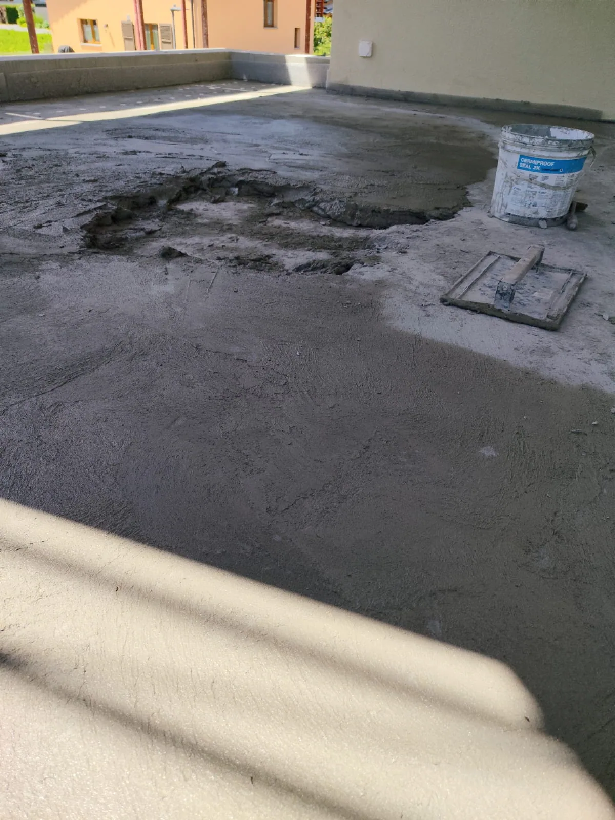 Mortar being applied across an outdoor terrace